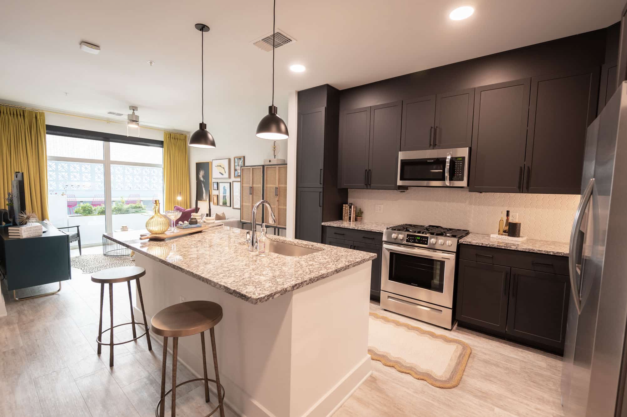 Furnished kitchen with island and barstools